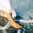 woman wearing paradise shells anklet on the beach